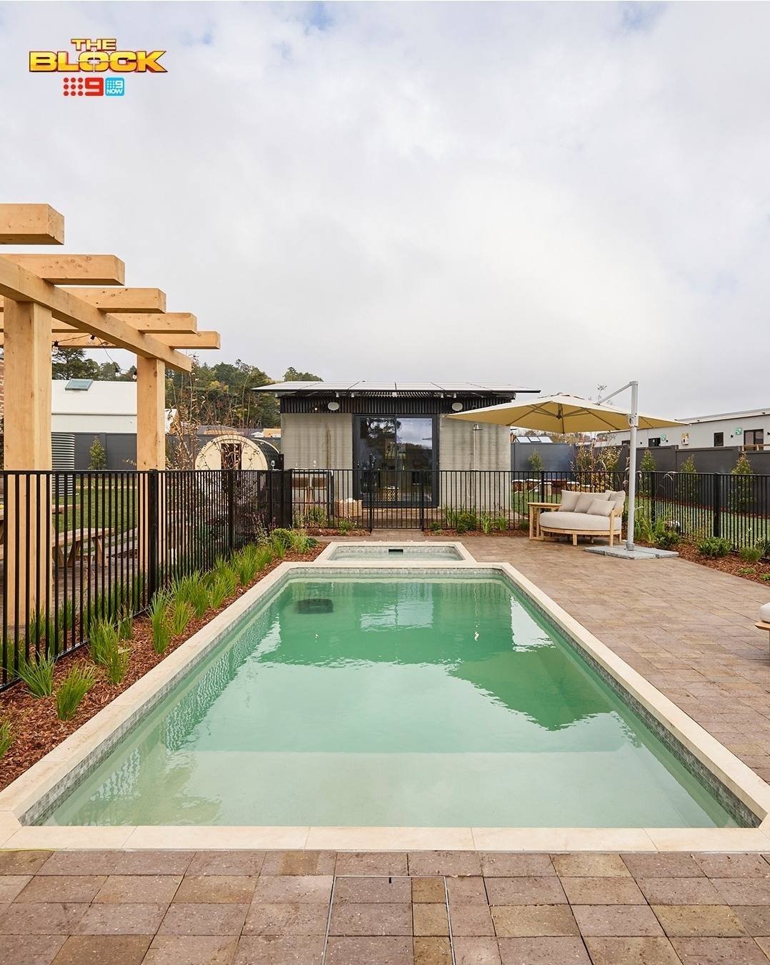 Paved pool surround with pergola and compliance fencing