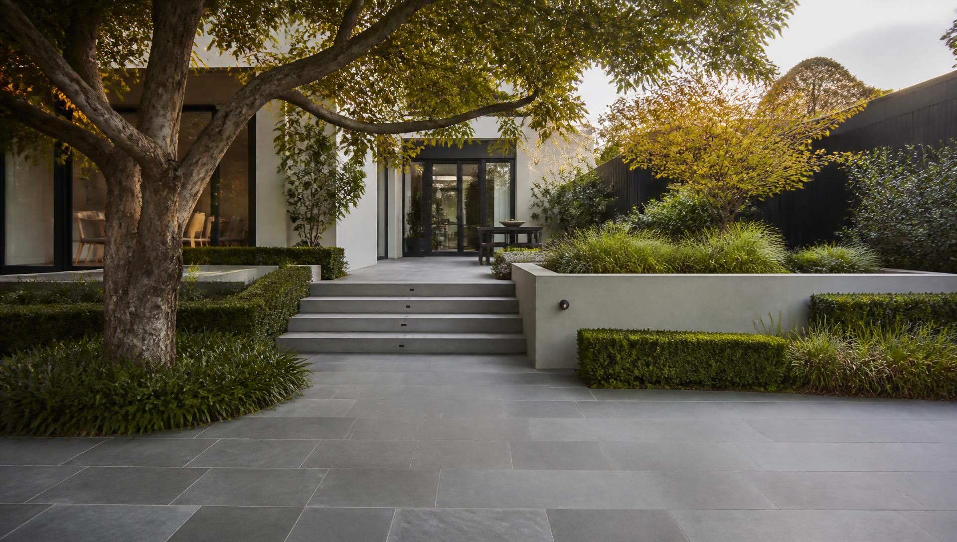 Completed residential landscape with stone paving and structured planting