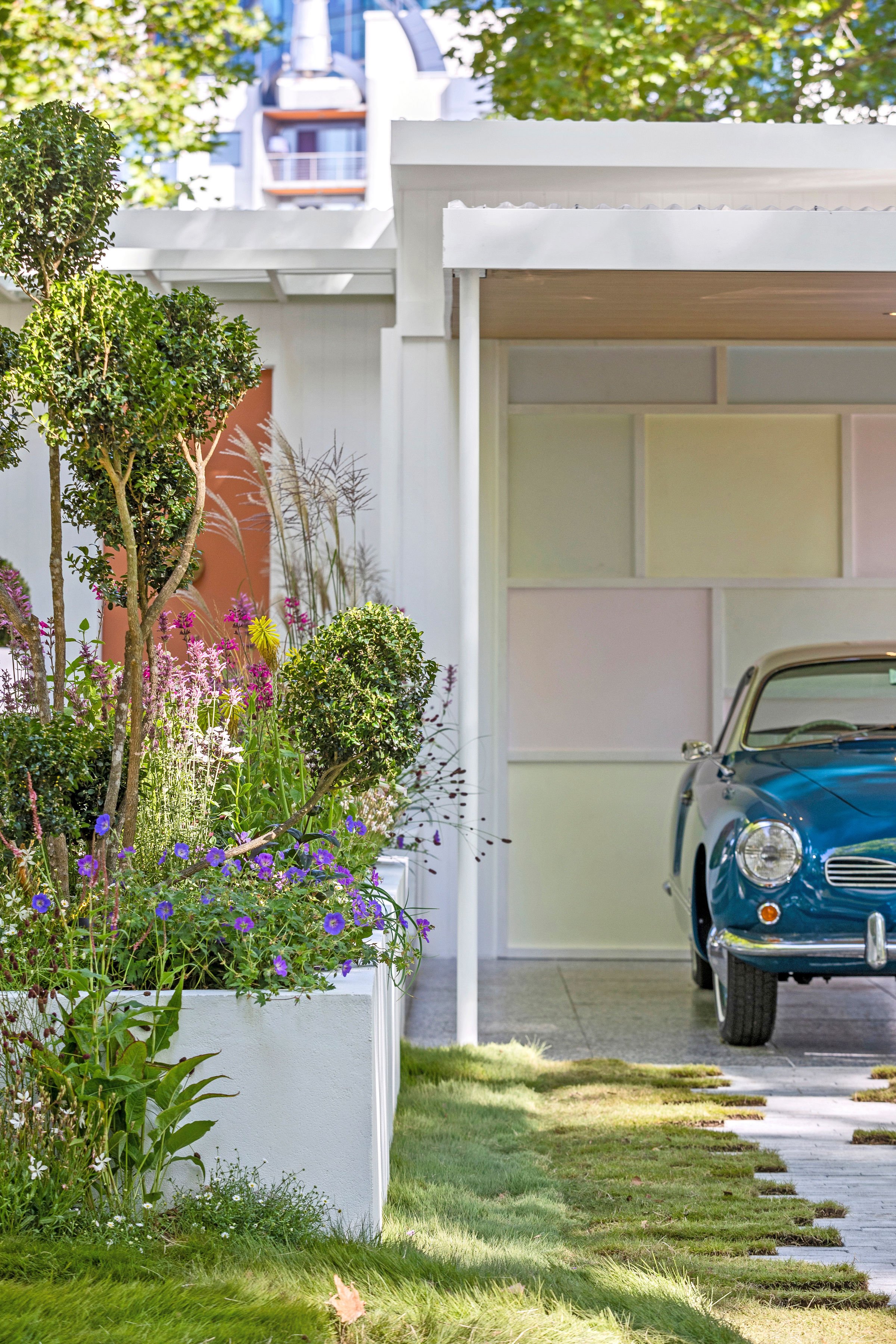 Rendered feature wall with topiary and carport structure